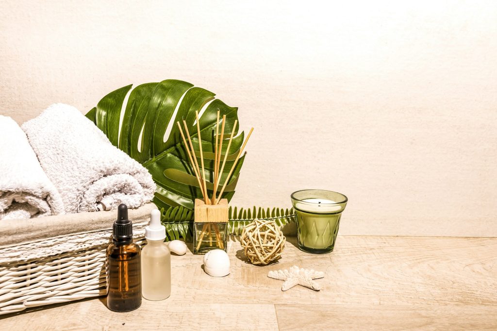 Spa day, composition with towels, oils bottles, candles, aromatherapy massage, relax, warm light